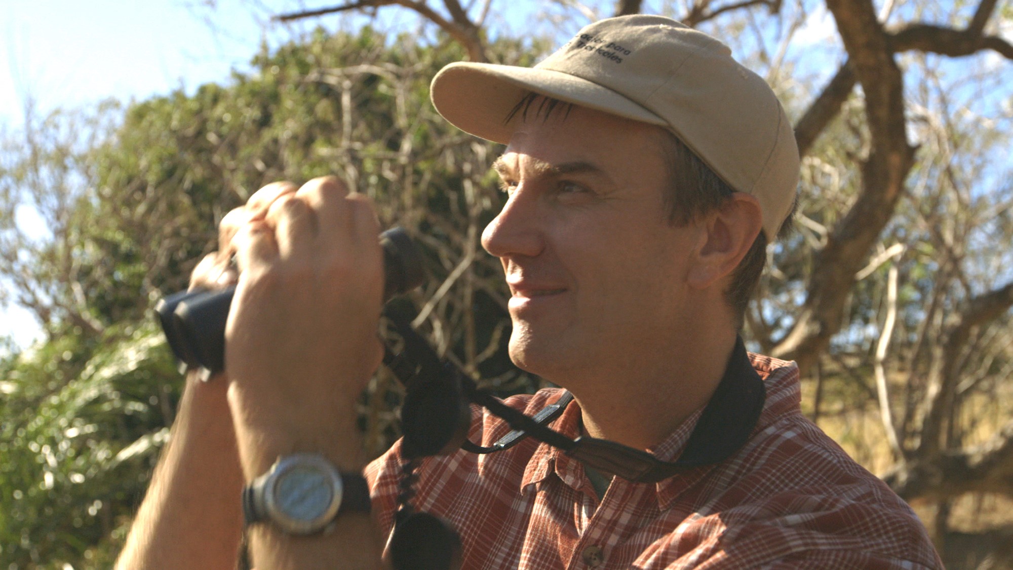 Dr. Tim Wright looking through binoculars